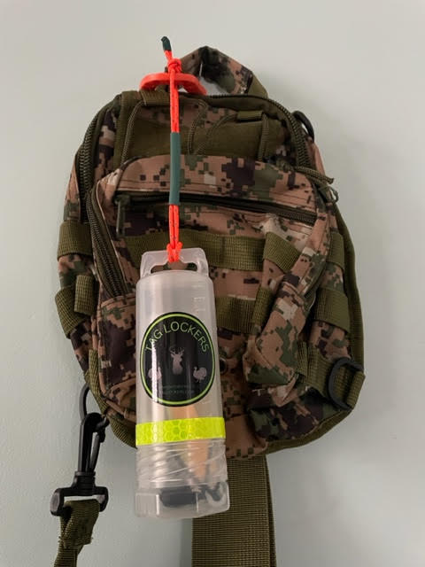 TagLocker 1.5 Inch with orange carabiner and a Digital Woodlands Camo Shoulder Bag